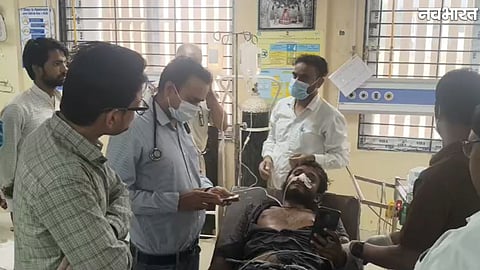 Joint Collector Milind Dhoke takes a youth to the district hospital