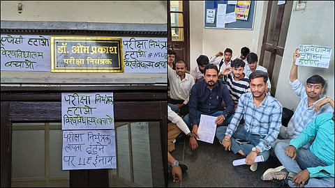 Students protest at Agra University put up posters declaring the Controller of Examinations missing.