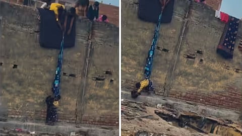 A shocking video of a child being lowered with a bedsheet to another rooftop has sparked outrage on social media.