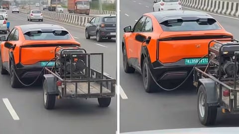 A viral video shows a man attempting to charge an electric car using a generator attached behind it.