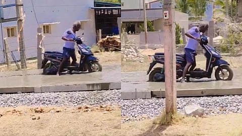 A man riding a scooty on a wet cement road went viral and sparked criticism online.