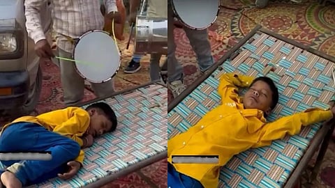 A child pretending to sleep to avoid school was hilariously “woken up” with a band, and the video has gone viral.