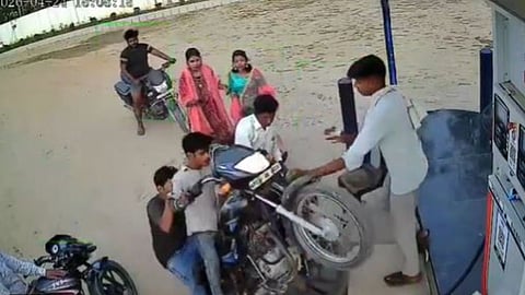A young man's attempt to impress girls at a petrol pump ended in embarrassment after his bike crashed into a worker.