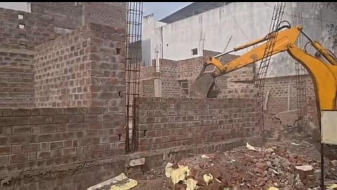 JCB demolishing an under-construction illegal house built on land reserved for a public garden in Suvidhi Nagar, Indore, during an Indore Municipal Corporation enforcement drive.