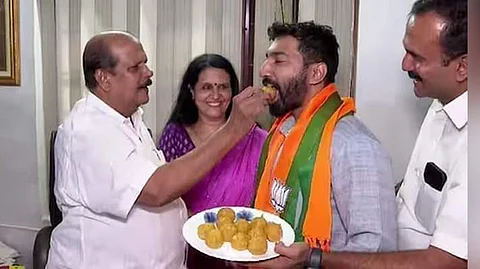 P C George offers sweets to BJP’s Pathanamthitta candidate Anil K Antony at his residence in Poonjar on Monday.