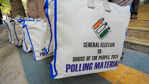 Electronic Voting Machines (EVM) and other election material being distributed from Nandanam Arts college to the respective polling booths on the eve of the first phase of Lok Sabha elections, in Chennai, Thursday, April 18, 2024.