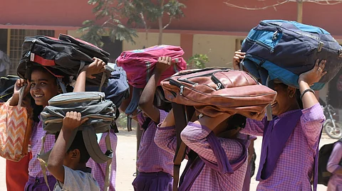Students shield themselves from the hot sun by covering their heads with school bags as they return home after a half-day of school in Tirupati. Image used for representational purposes only.