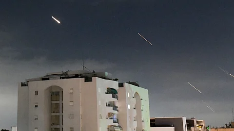 Israeli Iron Dome air defense system launches to intercept missiles fired from Iran, in central Israel, Sunday, April 14, 2024.