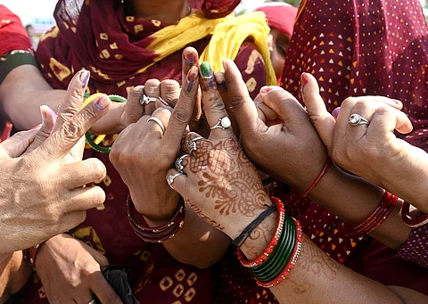 Voters show inked fingers after casting their votes for the sixth phase of the Lok Sabha Elections 2024, at Chautala village in Sirsa district, Haryana on Saturday.