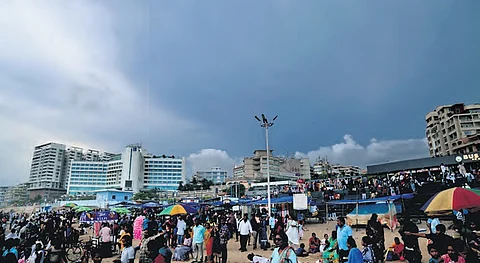 People seen enjoying a cool weather as dark clouds hover over RK Beach in Visakhapatnam on Sunday