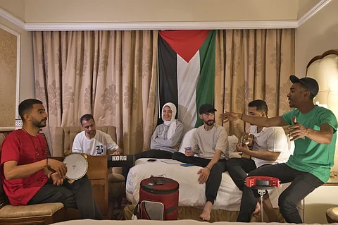 From left, Fares Anbar, Abood Qassim, Rahaf Shamaly, Hamada Nasrallah, Ahmed Haddad and Said Fadel of the Gaza Strip-based Sol Band prepare for a practice session in Doha, Qatar, Friday, May, 3, 2024.
