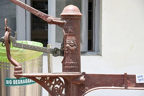 A British-era weighing scale with the royal emblem.