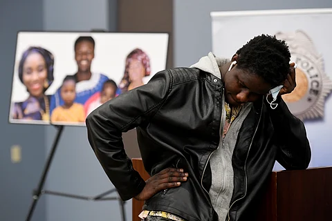 Abou Diol holds his head by the family picture of his brother Djibril Diol after a news conference by Denver Police at Denver Police Crime Laboratory in Denver, Wednesday, Jan. 27, 2021.
