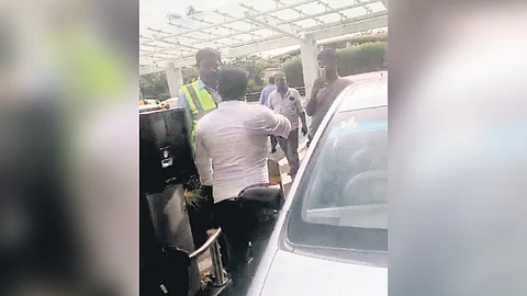 A driver argues with a staffer at the KIA Arrivals zone on Monday