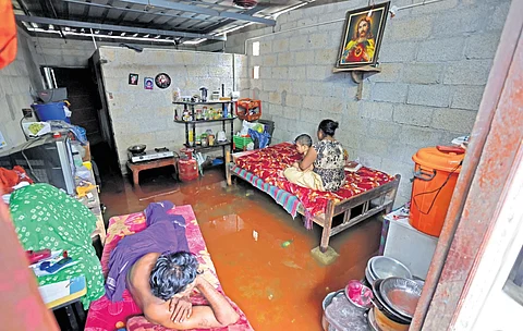 Varghese, wife Ramya and child in their one-room house at Balanagar near Vettukadu that was inundated in the rain