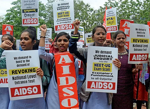 Members of AIDSO demanding Judicial enquiry into the NEET -UG exam scam during their protest at Freedom park in Bengaluru.