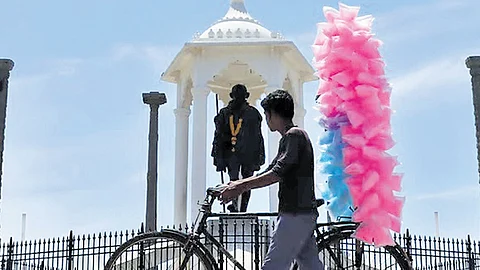 A hawker selling cotton candy on a bicycle