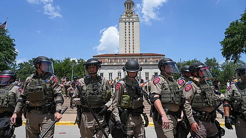 Texas state troopers line up below the University of Texas at Austin Tower to clear a pro-Palestinian encampment on the campus, April 29, 2024, in Austin, Texas.