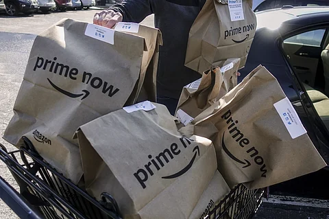 Amazon Prime Now bags are loaded for delivery outside a Whole Foods store on Feb. 8, 2018, in Cincinnati.