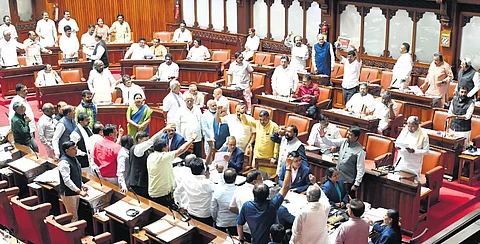Chief Minister Siddaramaiah addresses the Council, even as Opposition members crowd the well of the House, in Vidhana Soudha on Monday.