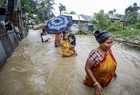 Womens' walking through the flood water in Assam