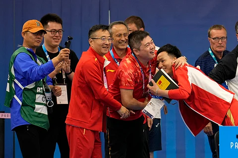 China's team celebrates after Huang Yuting and Sheng Lihao won the gold medal in the 10m air rifle mixed team competition at the 2024 Summer Olympics, Saturday, July 27, 2024.