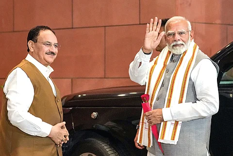 PM Narendra Modi being welcomed by Union minister and BJP president JP Nadda as he arrives to meet party workers at the BJP headquarters on Thursday.