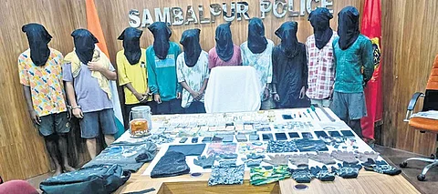 The accused along with seized items at district police headquarters.