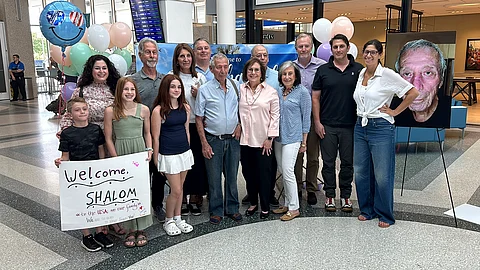 Shalom Korai poses for a picture with members of his extended family just after he met them in person for the first time.