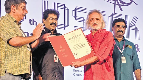 Rakesh Sharma, non-fiction jury chairman, presenting the awards for best long documentary and best editing to filmmaker Anand Patwardhan at the 16th IDSFFK in Thiruvanathapuram on Wednesday