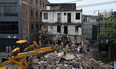 Rescue workers carry out the operation after a house collapsed at Jahangirpur industrial area in New Delhi on Friday.