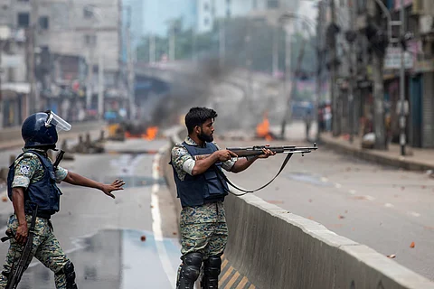Smoke rises from the burning vehicles after protesters set them on fire near the Disaster Management Directorate office, during the ongoing anti-quota protest in Dhaka on July 18, 2024.