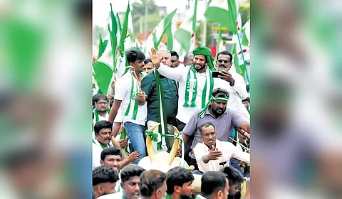 JDS Youth Wing president Nikhil Kumaraswamy and supporters ride a bullock cart during the BJP-JDS padayatra in Mandya on Wednesday.