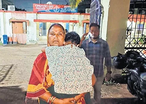 Nirmala Behera with her granddaughter at Paradip Lock police station.