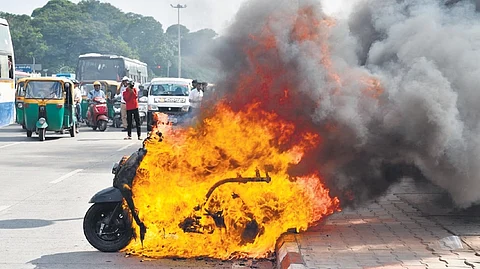 A scooter engulfed in flames after it was set ablaze by a man, near Vidhana Soudha in Bengaluru on Wednesday