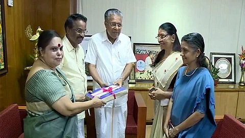 Kerala CM Pinarayi Vijayan receiving the report of the Hema Commission from Retired Justice K Hema.