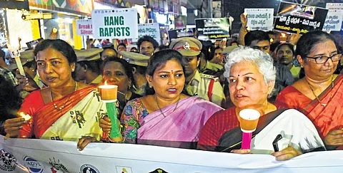 Home Minister V Anitha takes part in a candlelight march held in Vijayawada to condemn the rape and murder of a trainee doctor in Kolkata