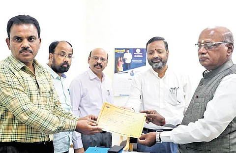 TPCC senior vice-president G Niranjan receives the election certificate from the returning officer on behalf of Abhishek Manu Singhvi