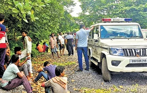 Police near the abandoned house where the body of the minor girl was found