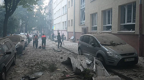 Local residents stand at the site of a missile attack in Lviv on September 4, 2024.