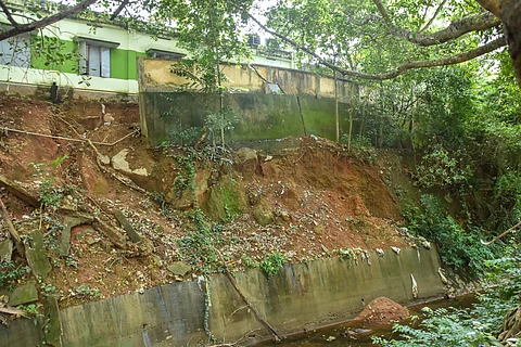 The damaged rear compound wall of Kattathurai government primary school is posing a threat to students in Kanyakumari district.