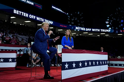 Republican presidential candidate former President Donald Trump, left, on stage with Arkansas Gov. Sarah Huckabee Sanders, right, during a town hall event at the Dort Financial Center, Tuesday, Sept. 17, 2024, in Flint, Mich.