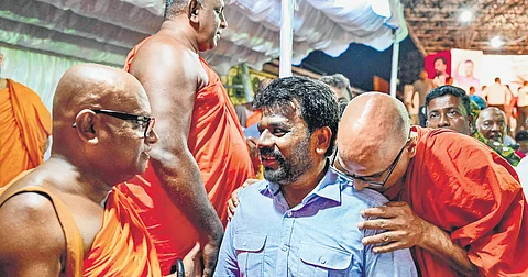 National People’s Power’s presidential candidate Anura Kumara Dissanayaka (3L), greets Buddhist monks during a rally in Colombo ahead of the Sept 21 poll.