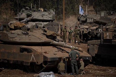 Israeli soldiers work on tanks and armoured personnel carriers (APC) in northern Israel, Monday, Sept. 30, 2024.