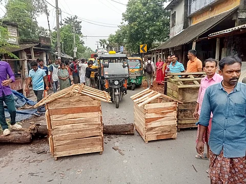 Irate villagers block a road as they stage a protest after an incident of alleged rape and murder of a young village girl in Kultali area of South 24 Parganas district, Saturday, Oct. 5, 2024.