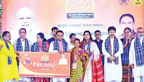 Chief Minister Mohan Charan Majhi and deputy CM Pravati Parida handing out assistance to a Subhadra Yojana beneficiary at Baripada on Wednesday