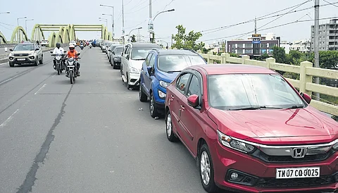 Cars parked on the Velachery bridge in Chennai in anticipation of widespread flooding from rains Bikes moving along a flooded street in Madurai