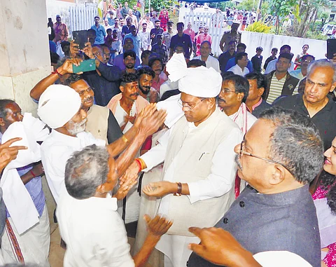 Komalikkudi tribal settlement chief Subramanian welcomes SC/ST parliamentary committee members with a turban to their settlement in Bisonvalley on Wednesday