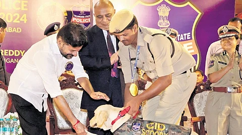 Chief Minister A Revanth Reddy shakes hand with a sniffer dog at the closing ceremony of Police Duty Meet-2024 at Telangana Police Academy on Saturday