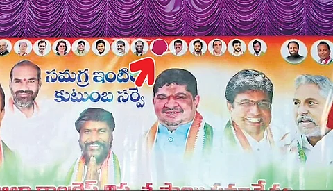 MLA M Sanjay Kumar’s photo is seen covered with a red sticker on a banner put up for a meeting on caste census in Jagtial on Sunday